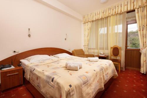 a bedroom with a large bed with towels on it at Arzni Health Resort in Arzni