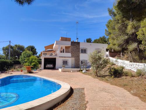 NáqueraにあるHermosa casa con piscina en Náquera, Valenciaの目の前にスイミングプールがある家