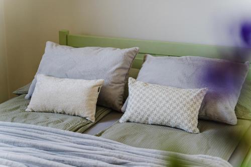 a bed with four pillows on top of it at La Nostra Villa in Zator