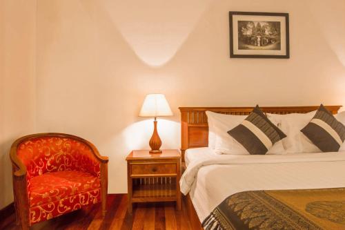 Ένα ή περισσότερα κρεβάτια σε δωμάτιο στο Cheathata CTA Hotel Siem Reap