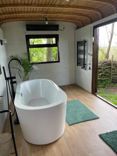 a large white tub sitting in a room at Flower Power in Anna Paulowna