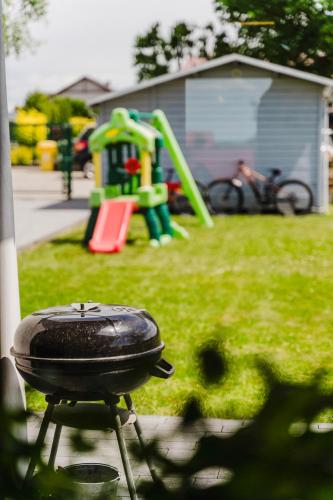 a bbq grill in front of a playground at La Nostra Villa in Zator