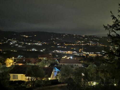 a view of a city at night with lights at Casa Leonardo a Poggi in Imperia