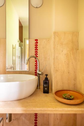 a bathroom counter with a sink and a mirror at Tenuta Moncarlino in Morsasco