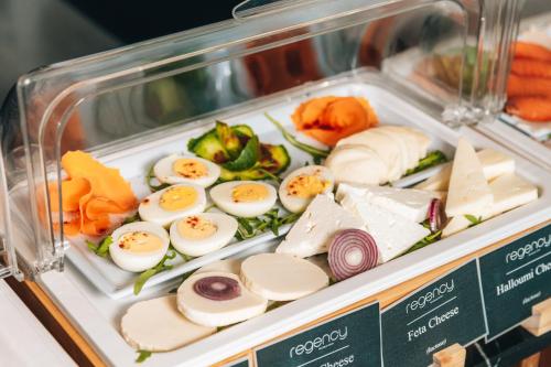 a display case with eggs and vegetables and cheese at Regency Boutique Hotel Holiday Suites in Paphos