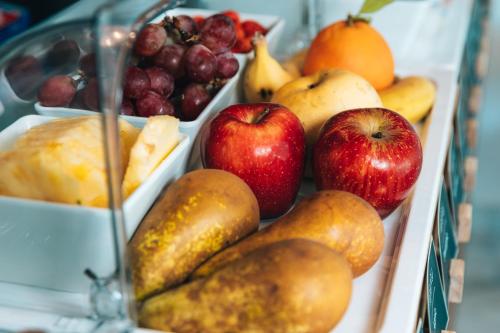 a bunch of fruits and vegetables in a tray at Regency Boutique Hotel Holiday Suites in Paphos