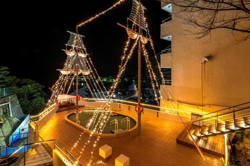 two christmas lights on a ship at night at Hotel Sanrakuso in Shirahama