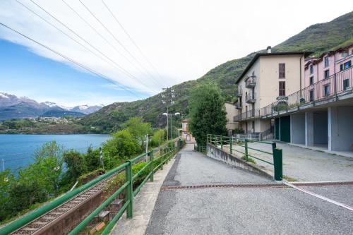 a walkway next to a building next to a body of water at Locanda Dell'Era in Dorio