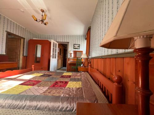 a bedroom with a bed with a quilt on it at Janune Kägu in Koeru