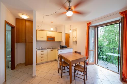 a kitchen with a table and a dining room at Locanda Dell'Era in Dorio