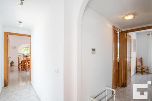 a hallway with a mirror and a dining room at Apartamento Racodifach 2B - Grupo Turis in Calpe