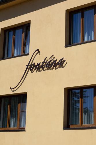 a sign on the side of a building at Pension Fontana in Poděbrady