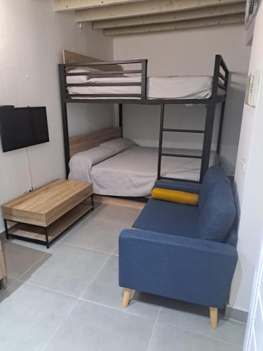 a living room with a bunk bed and a blue couch at Triana75 in Seville
