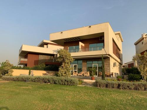 a large building with a lawn in front of it at Awesome Villa on a hill Families only in Cairo