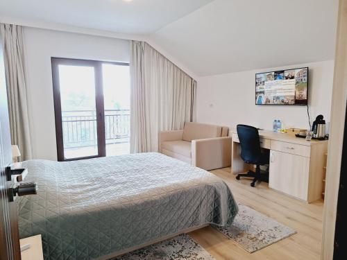 a bedroom with a bed and a desk and a chair at TREND - cazare, gradina, piscina in Arad