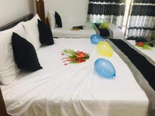 a large white bed with balloons on top of it at Nice Place Kandy in Kandy