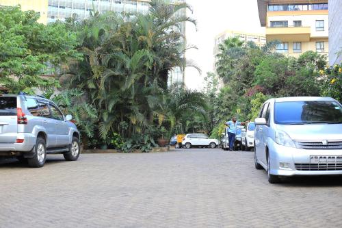 a group of cars parked in a parking lot at ACK Guest House Nairobi in Nairobi