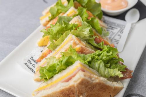 a sandwich with lettuce and tomatoes on a plate at Hotel Mioni Royal San in Montegrotto Terme