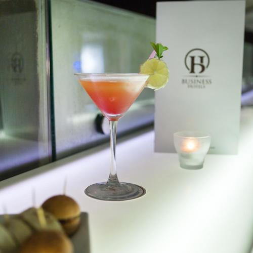 a drink in a martini glass sitting on a counter at Business Hotel in Tunis