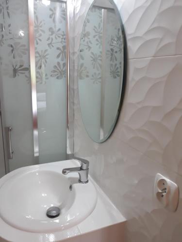 a bathroom with a sink and a mirror at Drewniana Oaza in Ochotnica Dolna