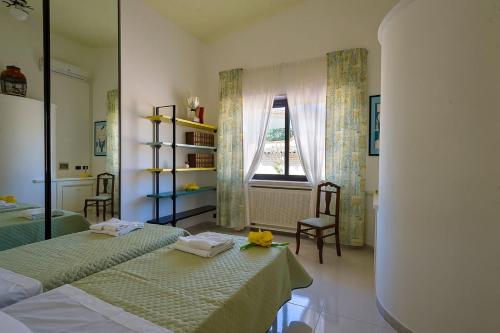a bedroom with two beds and a window at Villa Galatea al mare - Tonnarella in Mazara del Vallo