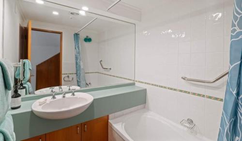 a bathroom with a sink and a mirror at Aspen Getaway in Queenstown