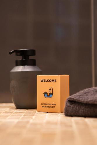 a welcome sign on a counter next to a soap dispenser at Villa vue mer, terrasse et spa in Nice