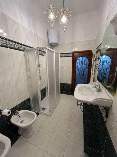 a bathroom with two sinks and a shower at Villa Olga in San Vincenzo