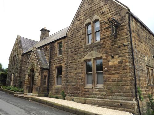 an old stone building on the side of a street at The Penny Bun in Otley