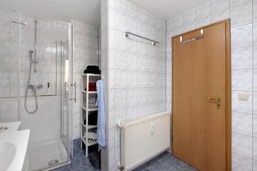 a bathroom with a shower and a sink and a showeriterator at Ferienhaus Koch in Bad Harzburg