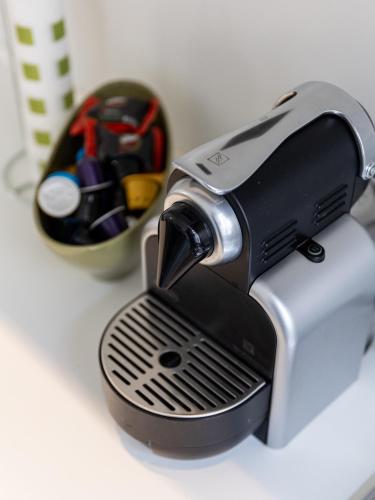 a toaster sitting on a counter next to a cup of pens at Casa Misette 200mq a due passi dal mare in Alassio