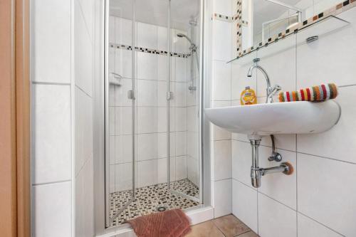 a bathroom with a sink and a shower at Haus Schöneck in Otterndorf