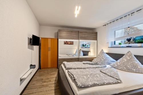 - une chambre avec un lit et une télévision dans l'établissement Ferienwohnung Am Weissgerber, à Münsingen