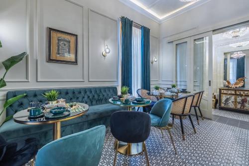 a living room with tables and chairs and a couch at Maison Medina Malta in Mdina