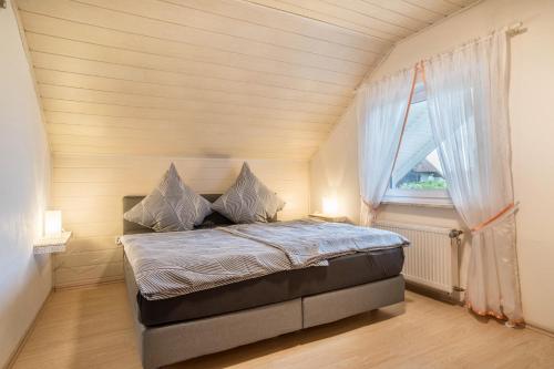 a bed in a small room with a window at Ferienwohnung Viola in Schwanau in Schwanau