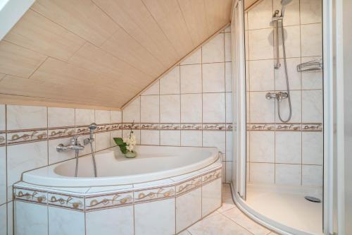 a bathroom with a tub and a shower at Ferienwohnung Viola in Schwanau in Schwanau