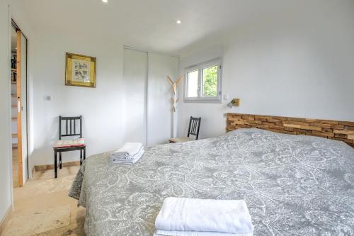 a bedroom with a large bed and a window at Gite Deodatus avec piscine in Cladech