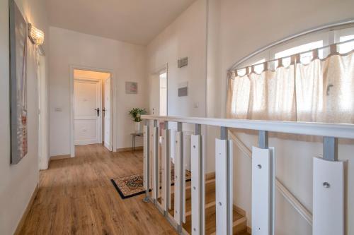 a staircase in a home with white walls and wood floors at Villa Sara in Sorso