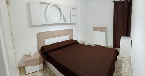 a bedroom with a bed in a white room at Apartamento vistas a piscina in Benalmádena