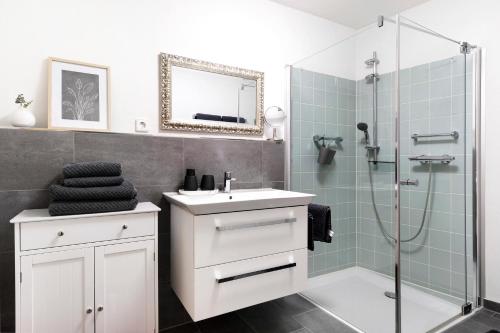 a bathroom with a sink and a shower at Ferienwohnung Zola in Ettenheim
