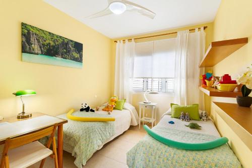 a bedroom with two beds with a surfboard on it at Isabel Home For Families in San Bartolomé de Tirajana