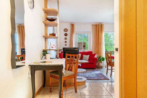a kitchen and living room with a table and chairs at Grotthof in Nova Ponente