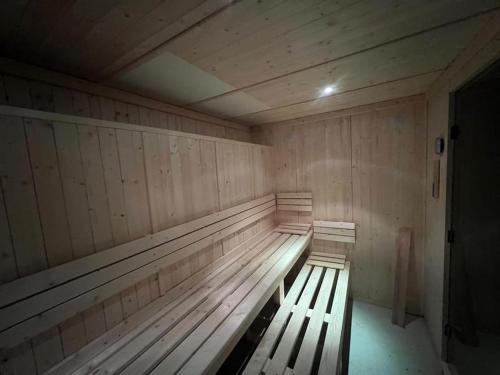 a empty wooden bench in a wooden room with at Chalet 12 places dans le Vercors in Corrençon-en-Vercors