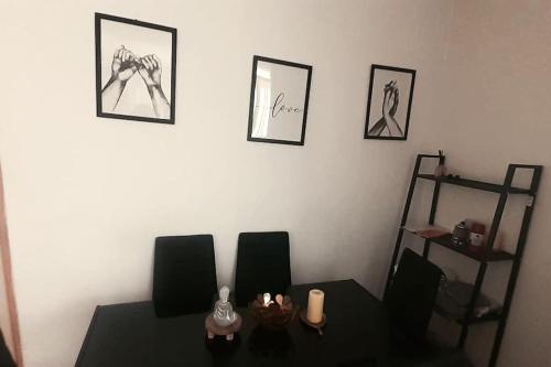 a dining room with a table and two chairs at Appartement spacieux à Cergy in Pontoise