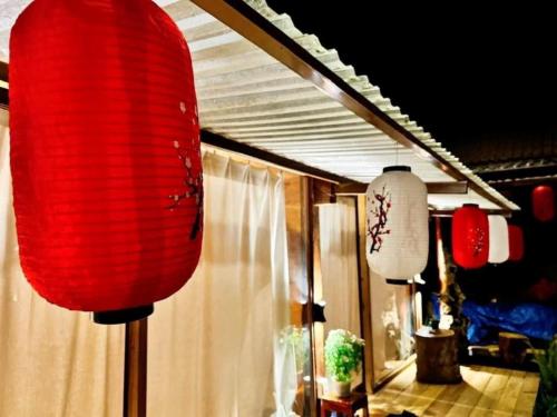 two red and white lanterns hanging in a room at Đồi Gió Hú Homestay & Coffee - Măng Đen in Kon Tum