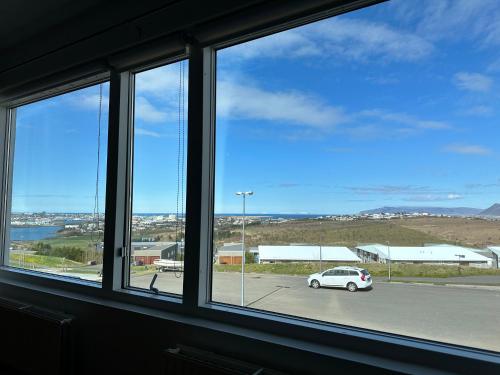 a window with a car parked in a parking lot at Apartment in Maríubaugur,with fantastic view over Reykjavik - Birta Rentals in Reykjavík