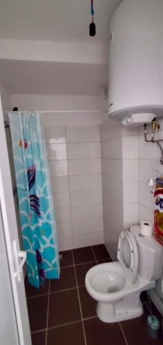 a small bathroom with a toilet with the lid up at Kevin&Elisa Your home! in Lezhë