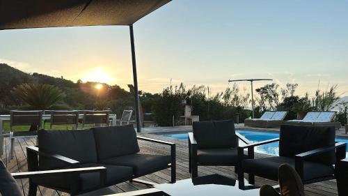 a patio with two chairs and a swimming pool at Résidence Aigue Marine in Coti-Chiavari