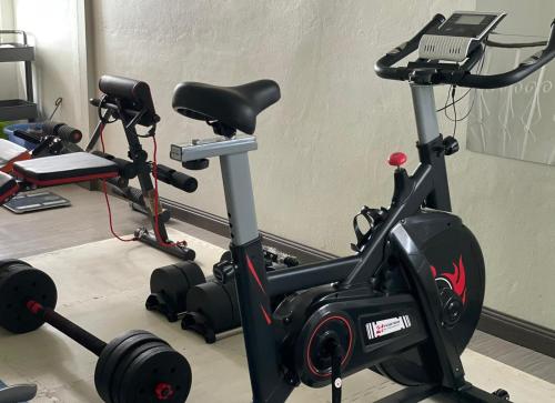 a gym with a treadmill and a exercise bike at Chanmel Riverside in Chanthaburi
