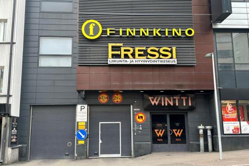 a building with a sign on the side of it at Solo Sokos Hotel Lahden Seurahuone in Lahti